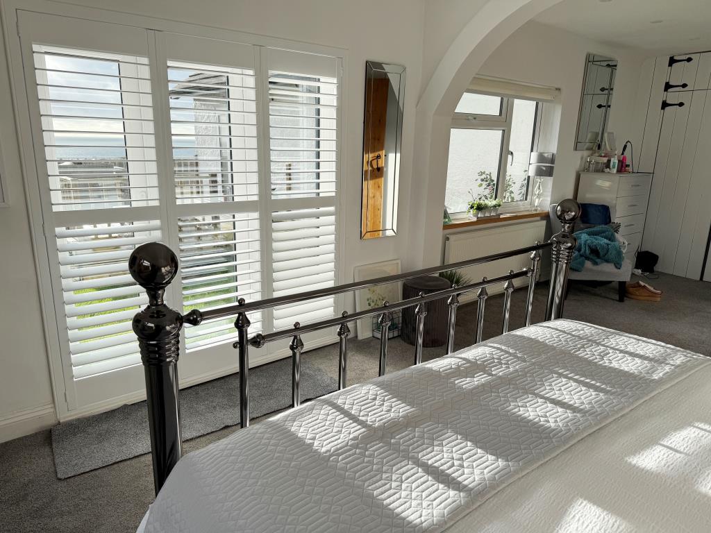 Lot: 62 - DETACHED HOUSE WITH SEA VIEWS PLUS ADJOINING LAND WITH PLANNING - Main bedroom with views and doors to decking